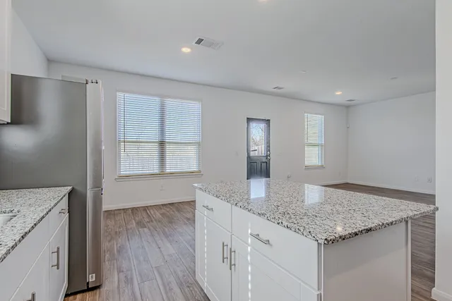 a kitchen with stainless steel appliances granite countertop a sink stove and cabinets