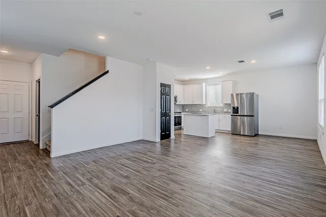 a view of kitchen with wooden floor and electronic appliances