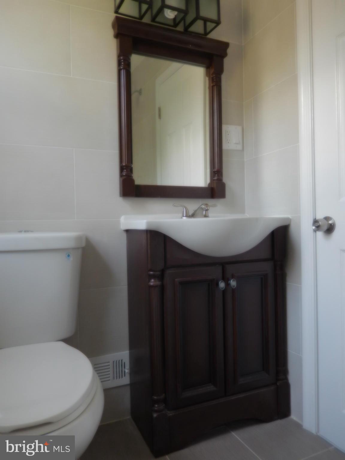 4301 Cedar Garden Road Baltimore, MD 21229 - Photo 12 of 29 a bathroom with a toilet and a sink