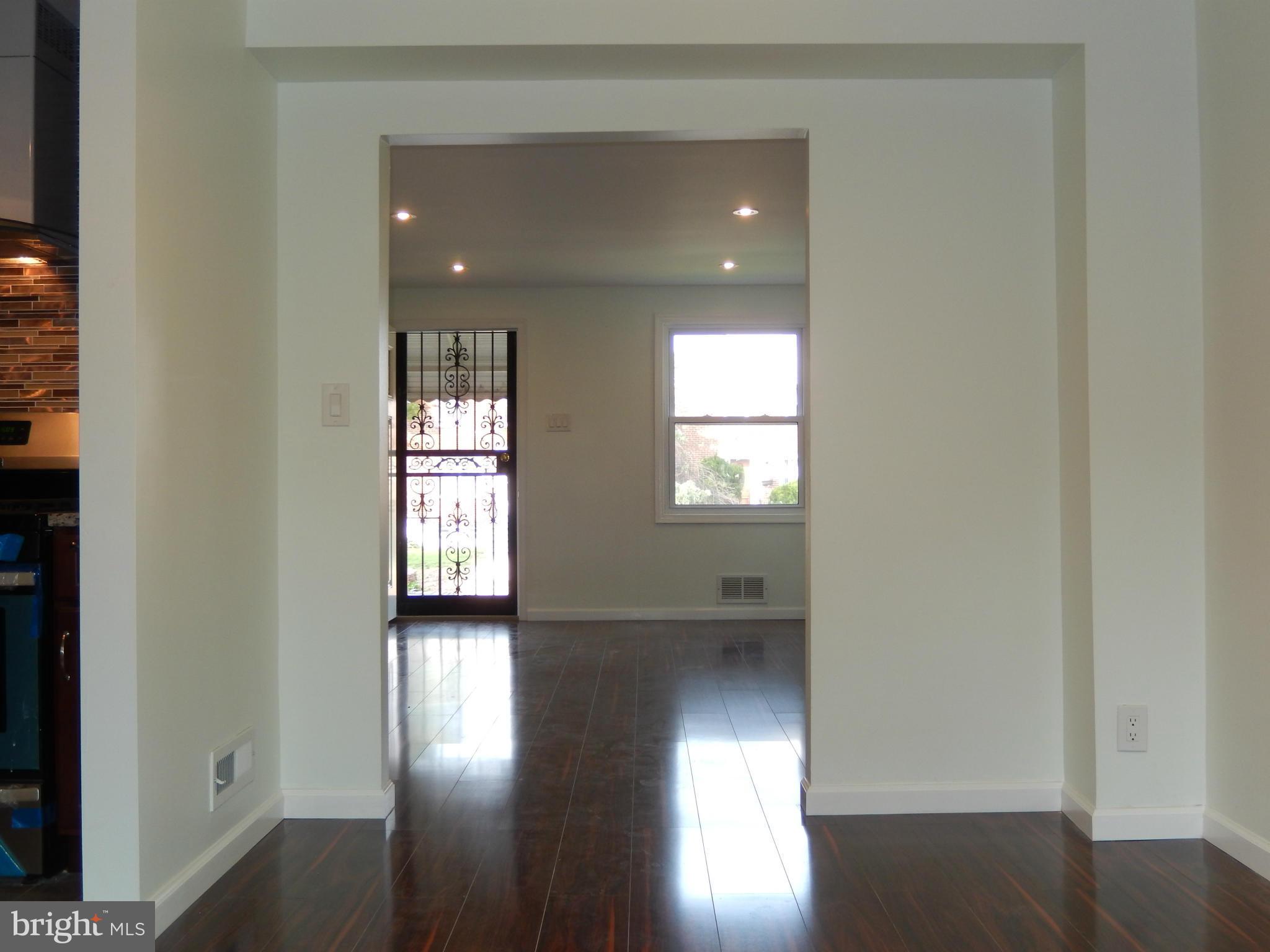 4301 Cedar Garden Road Baltimore, MD 21229 - Photo 14 of 29 a view of empty room with wooden floor and fan