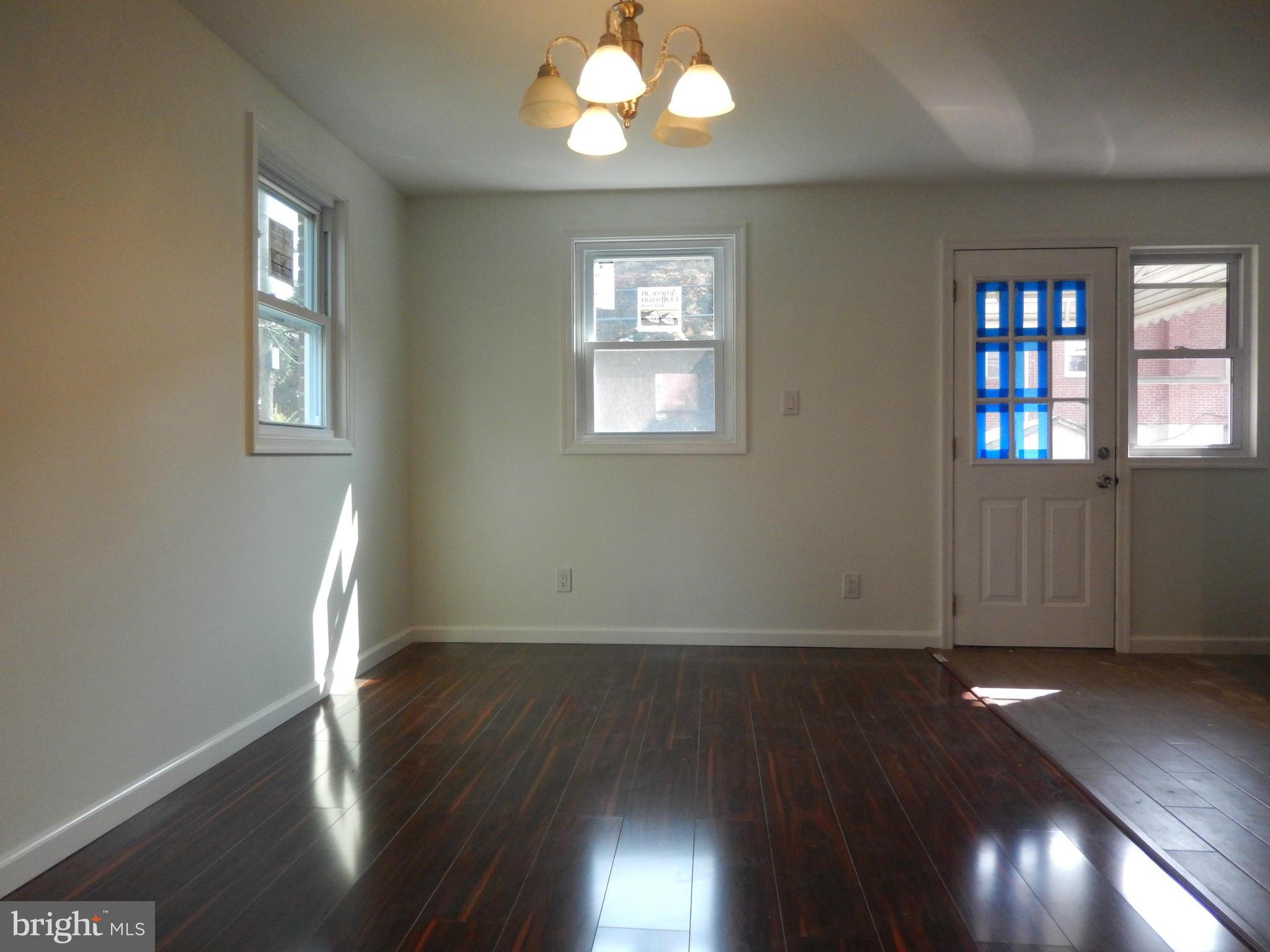 4301 Cedar Garden Road Baltimore, MD 21229 - Photo 16 of 29 an empty room with wooden floor and windows