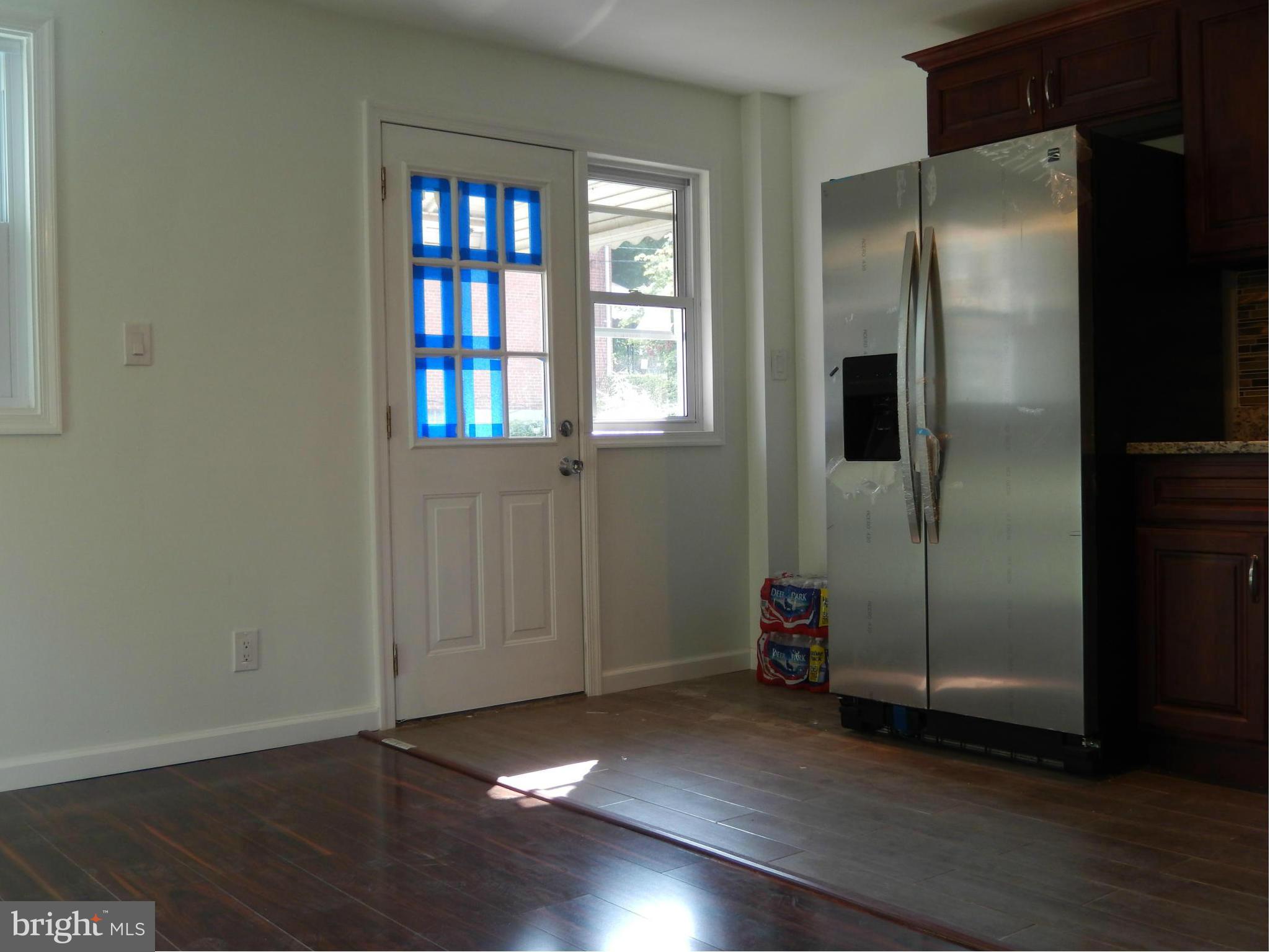 4301 Cedar Garden Road Baltimore, MD 21229 - Photo 22 of 29 a view of an empty room with wooden floor and a window