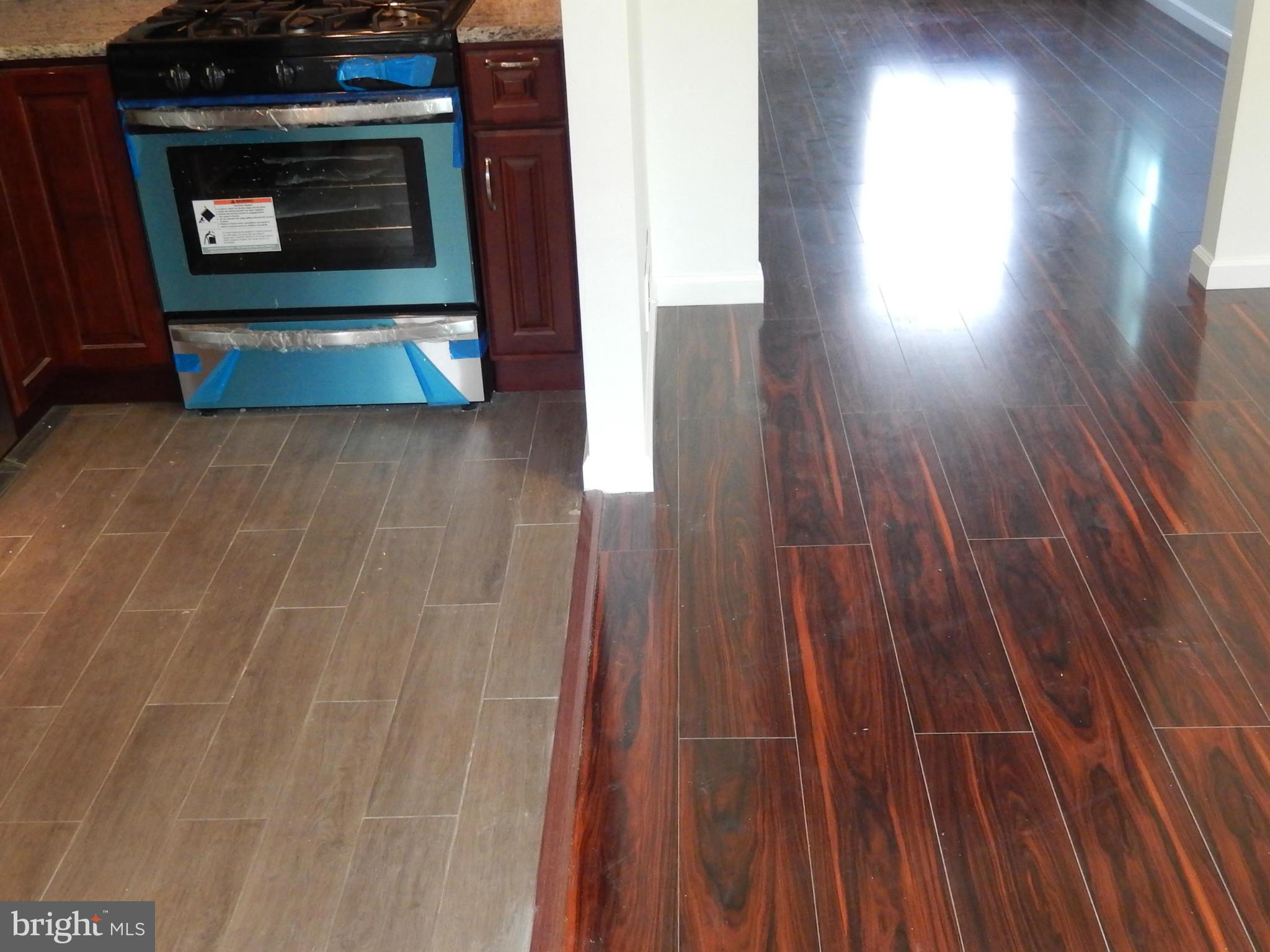 4301 Cedar Garden Road Baltimore, MD 21229 - Photo 23 of 29 a living room with wooden floor and a fireplace