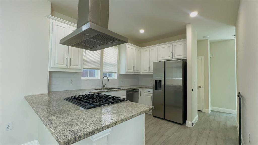 2239 Anderson Street Dallas, TX 75215 - Photo 4 of 16 a kitchen with a stove a refrigerator and a cabinets