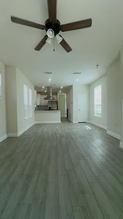 a view of a livingroom with hardwood floor and a ceiling fan