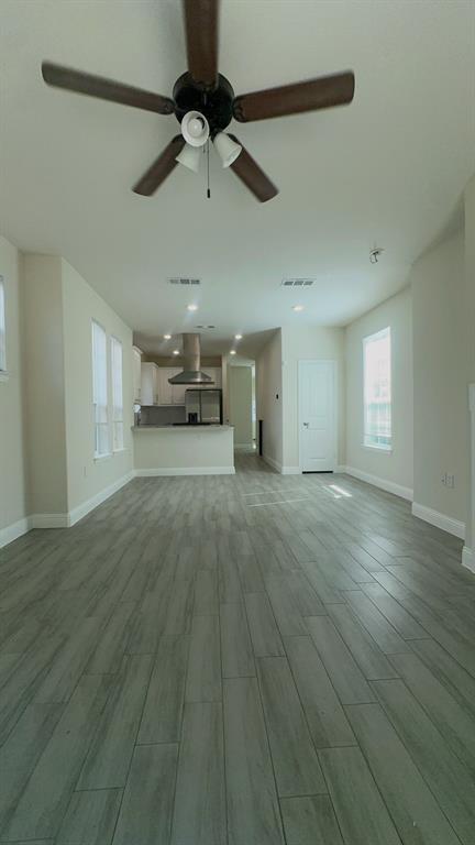 2239 Anderson Street Dallas, TX 75215 - Photo 7 of 16 a view of a livingroom with hardwood floor and a ceiling fan