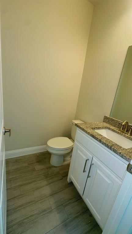 2239 Anderson Street Dallas, TX 75215 - Photo 8 of 16 a bathroom with a granite countertop toilet and a sink