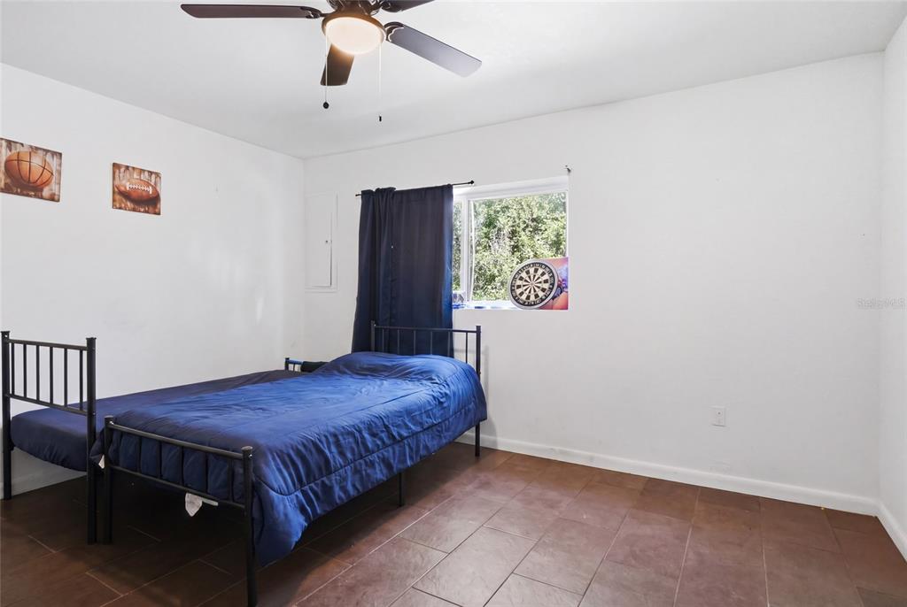401 Southeast Falcon Road Branford, FL 32008 - Photo 35 of 76 a bedroom with a bed and a chandelier