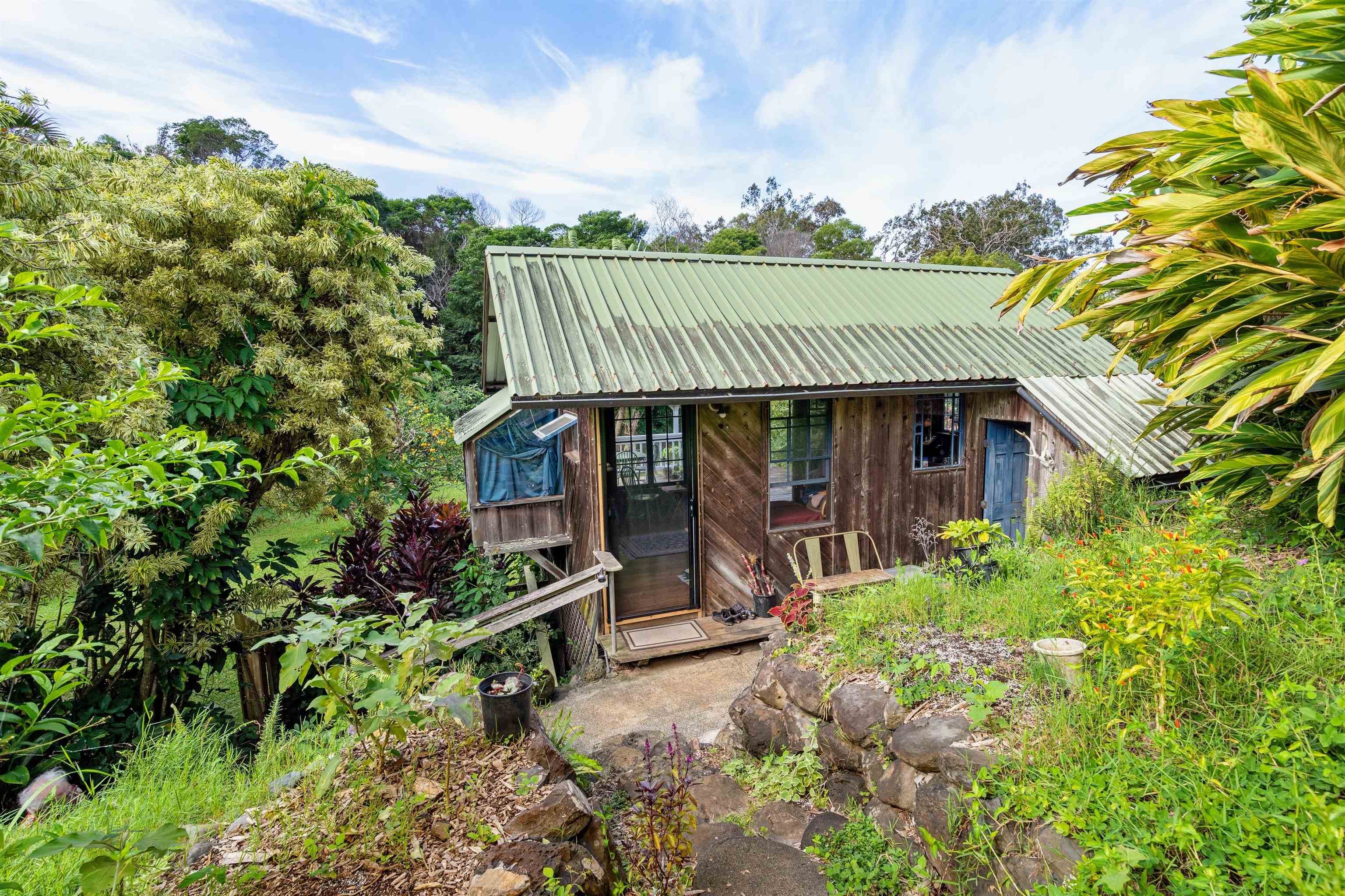 1870 West Kuiaha Road Haiku, HI 96708 - Photo 15 of 27 front view of a house with a garden