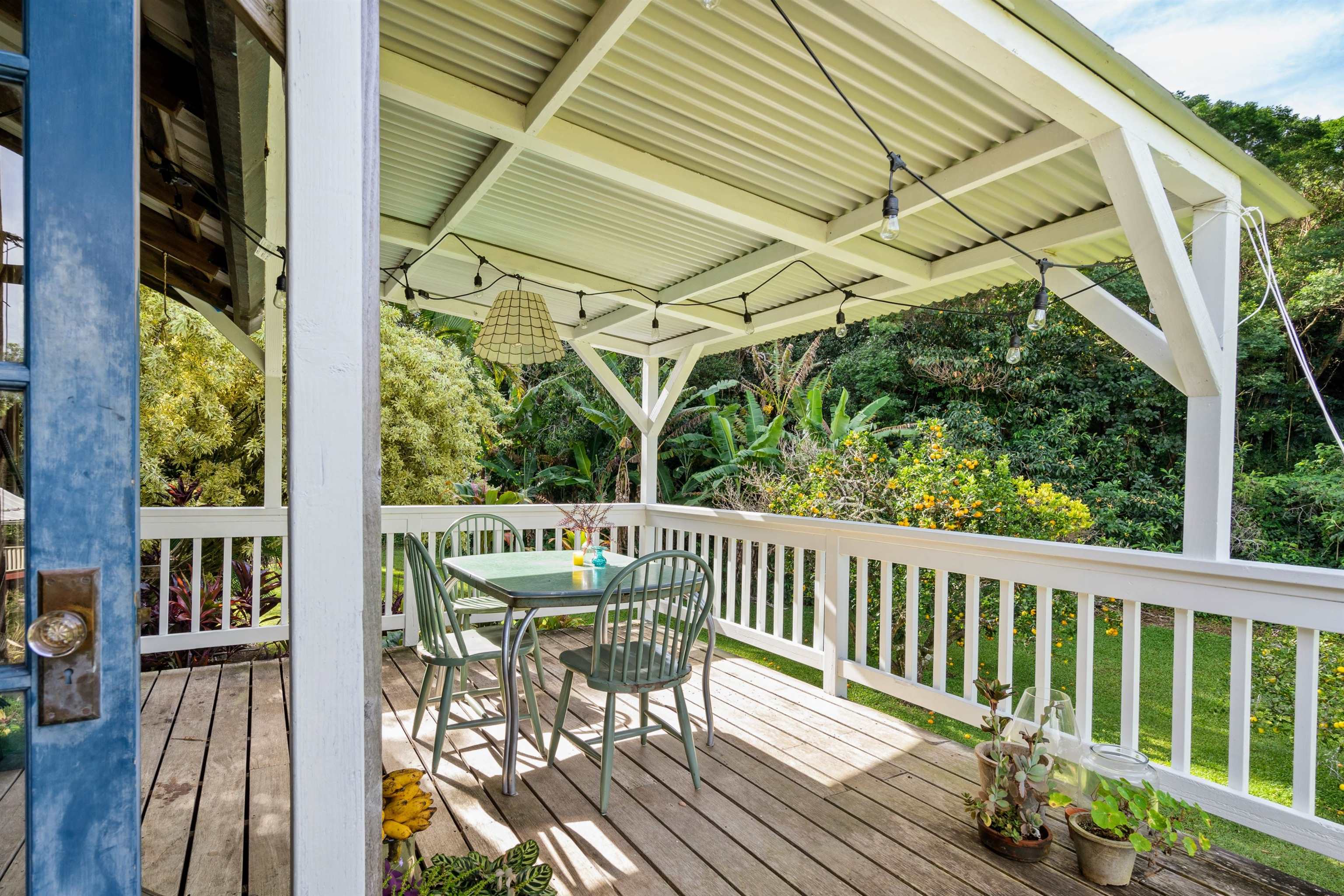 1870 West Kuiaha Road Haiku, HI 96708 - Photo 18 of 27 a view of balcony with wooden floor and outdoor seating