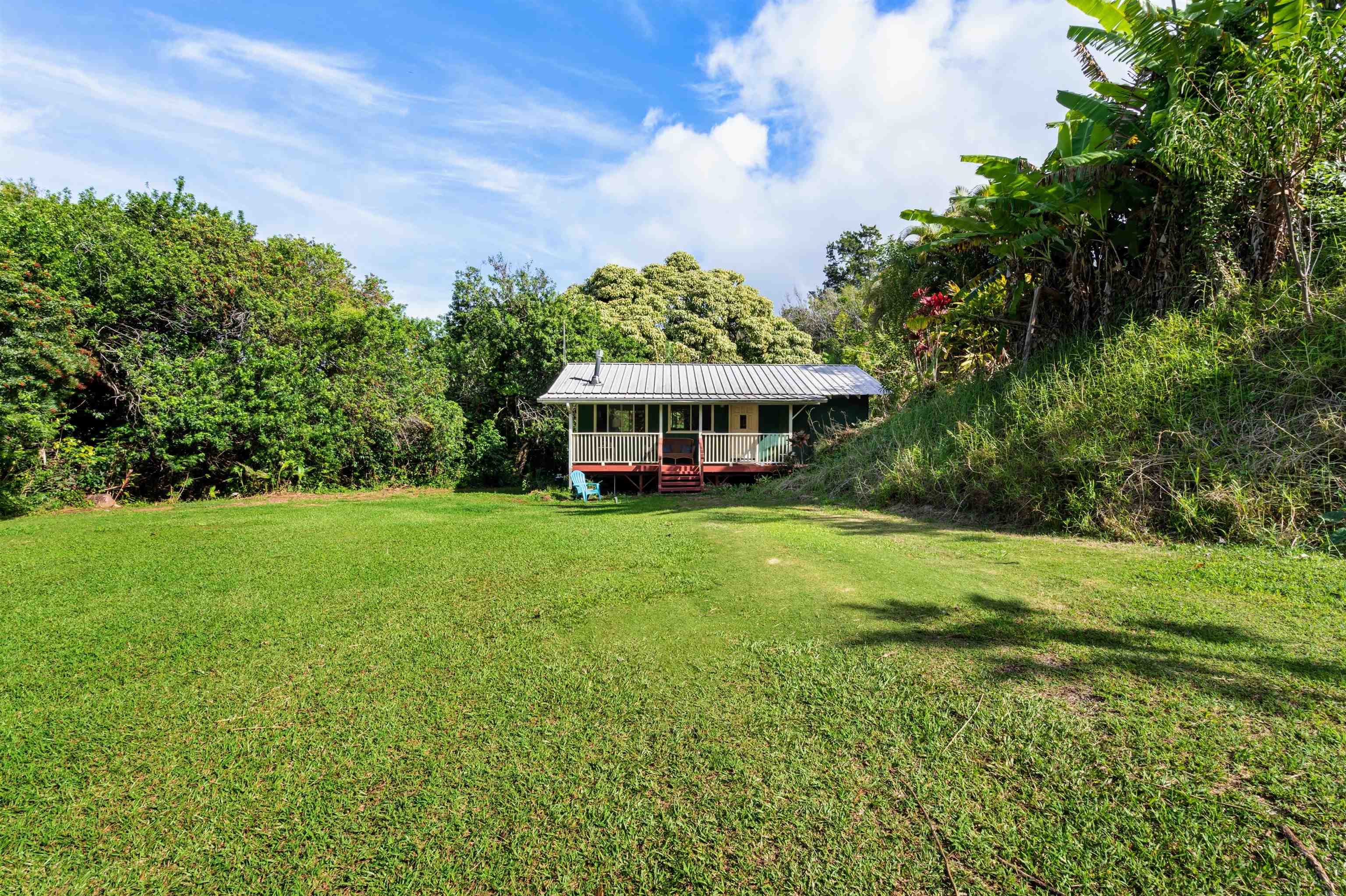 1870 West Kuiaha Road Haiku, HI 96708 - Photo 3 of 27 a front view of a house with a yard