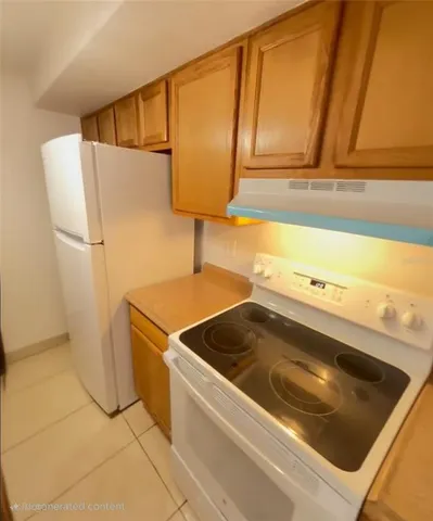 a kitchen with a sink and a refrigerator