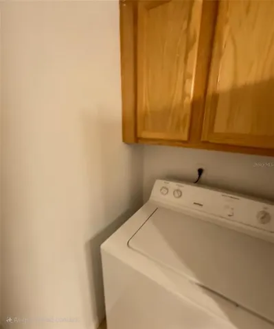 a kitchen with granite countertop a sink a stove and a refrigerator