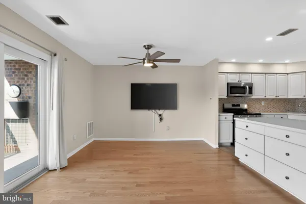 a living room with granite countertop furniture and a flat screen tv