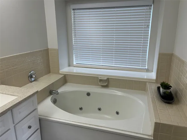 a bathroom with a tub and a sink