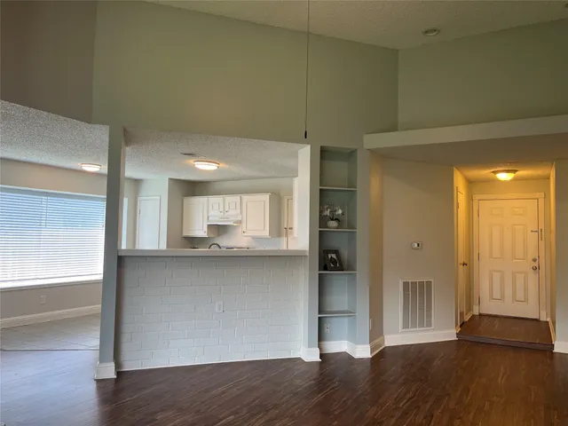 a view of a kitchen cabinets and wooden floor