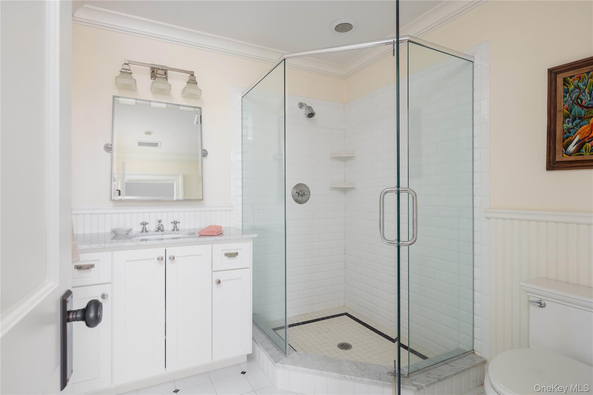 53 Cedar Lane West Remsenburg, NY 11960 - Photo 26 of 38 Full bath with a wainscoted wall, toilet, a stall shower, and ornamental molding
