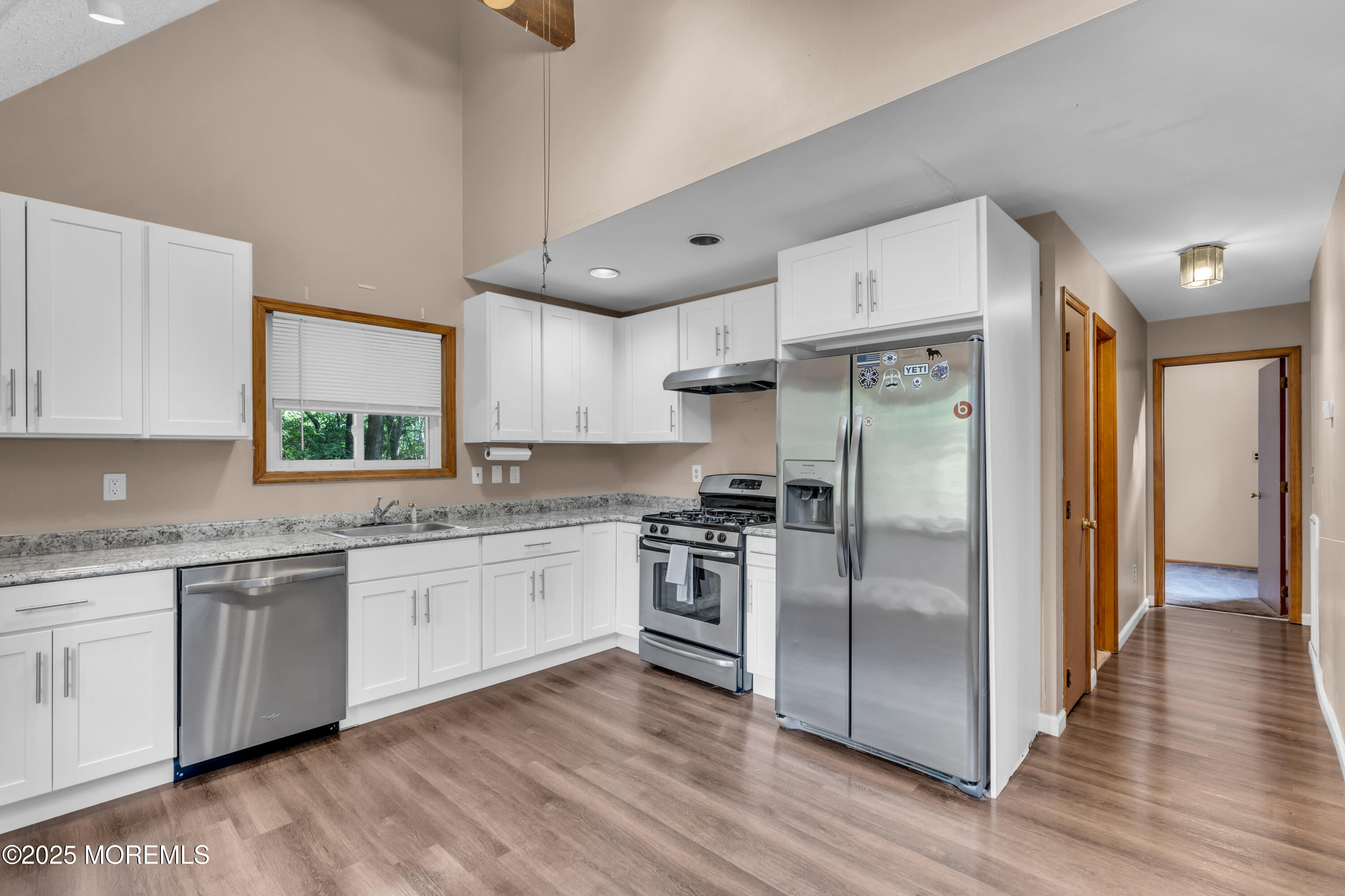 1623 Church Road Toms River, NJ 08755 - Photo 11 of 37 a kitchen with stainless steel appliances granite countertop a refrigerator a sink dishwasher a stove and white countertops with wooden floor