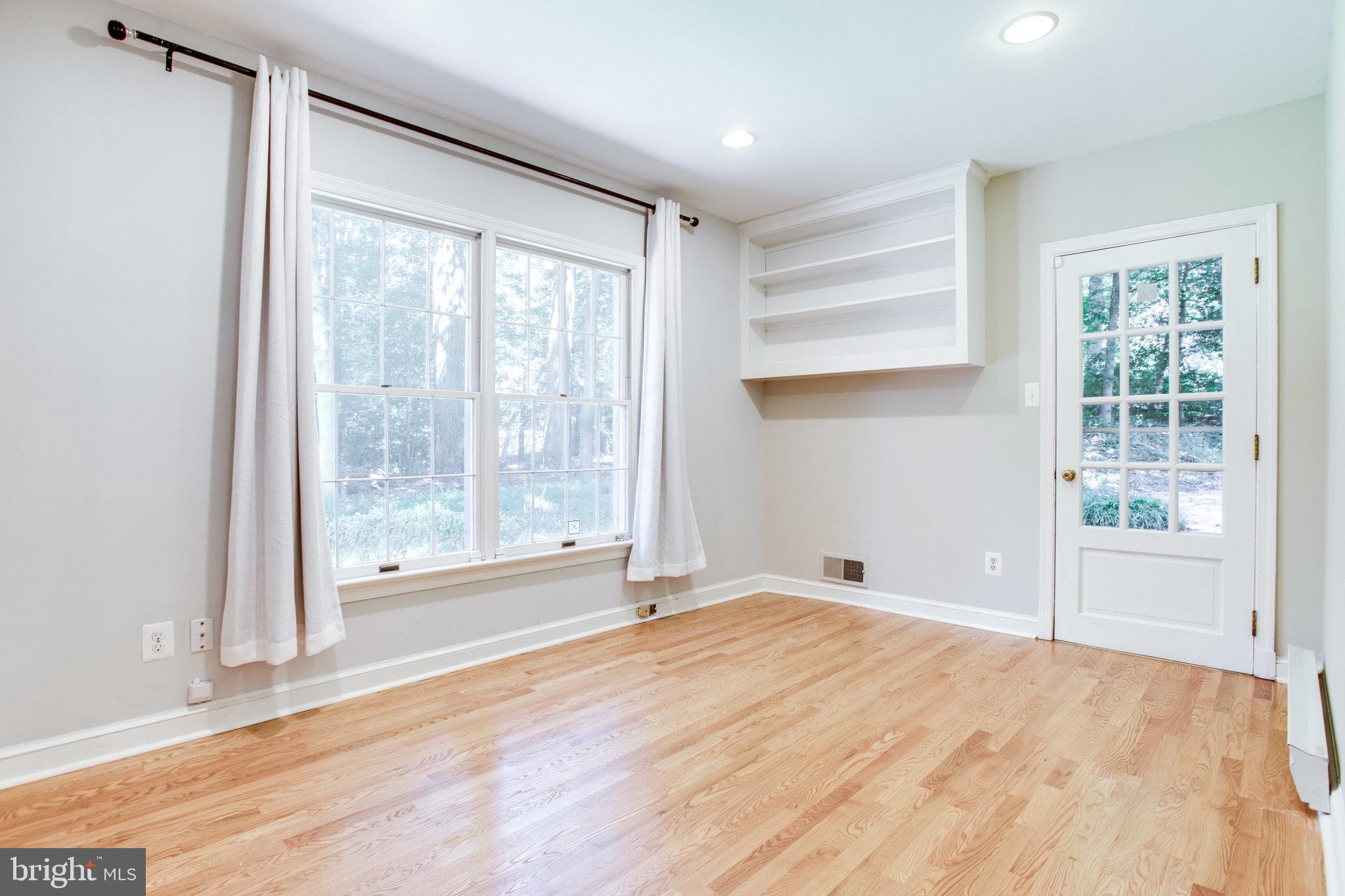 8500 Brook Road McLean, VA 22102 - Photo 19 of 52 a view of an empty room with a window and wooden floor