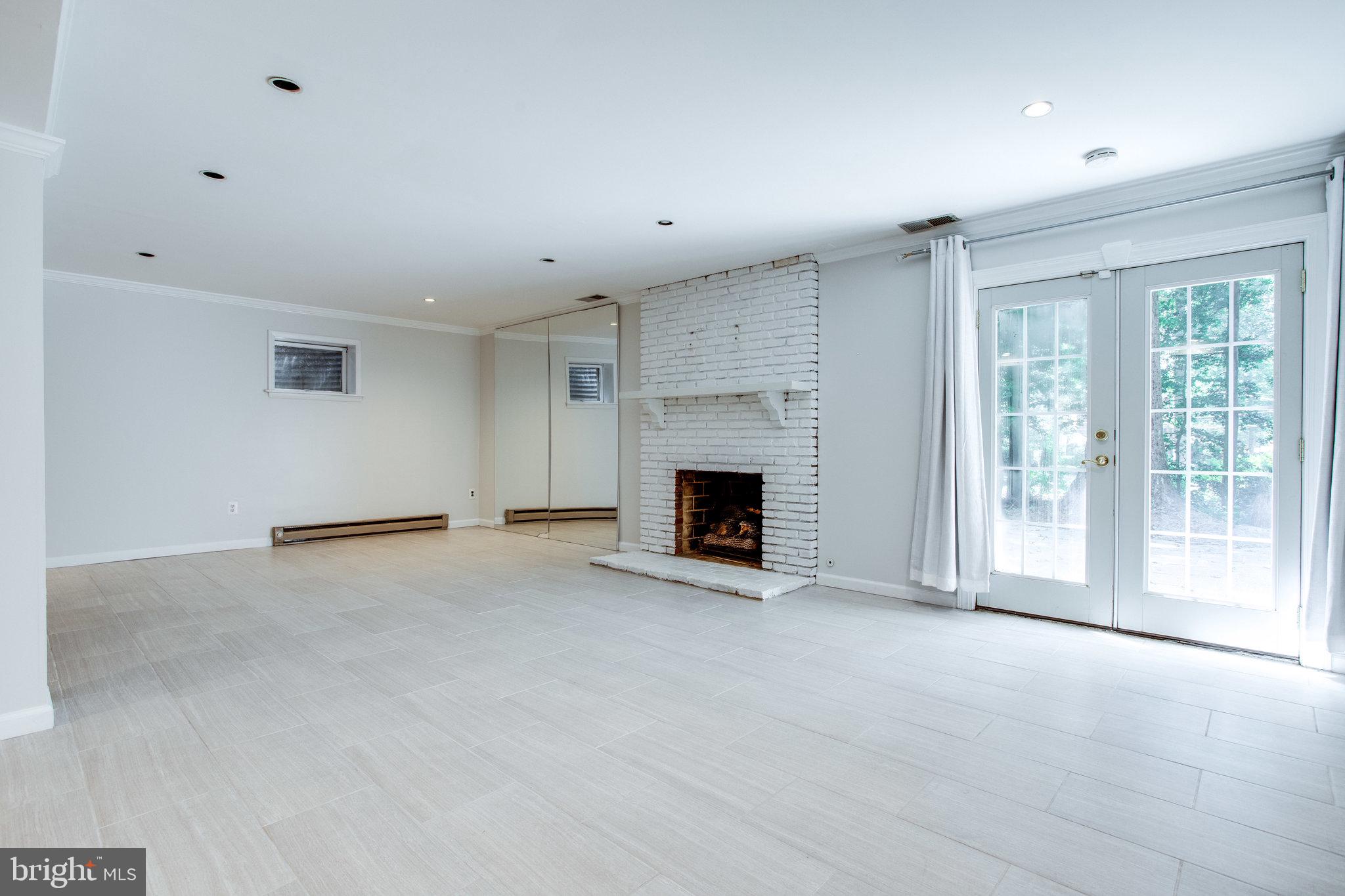 8500 Brook Road McLean, VA 22102 - Photo 40 of 52 a view of an empty room with a fireplace and a window