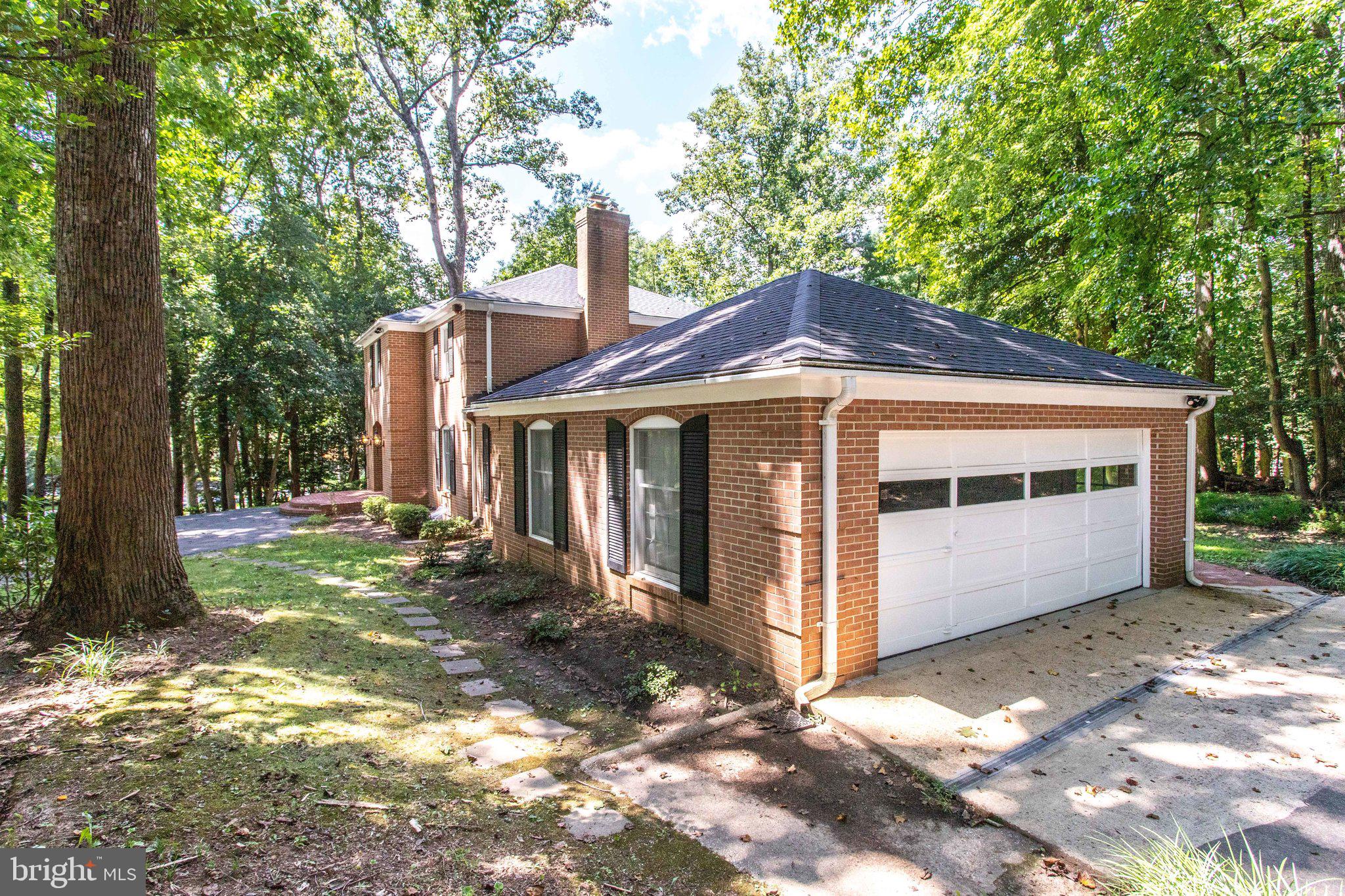 8500 Brook Road McLean, VA 22102 - Photo 46 of 52 a front view of a house with a garden