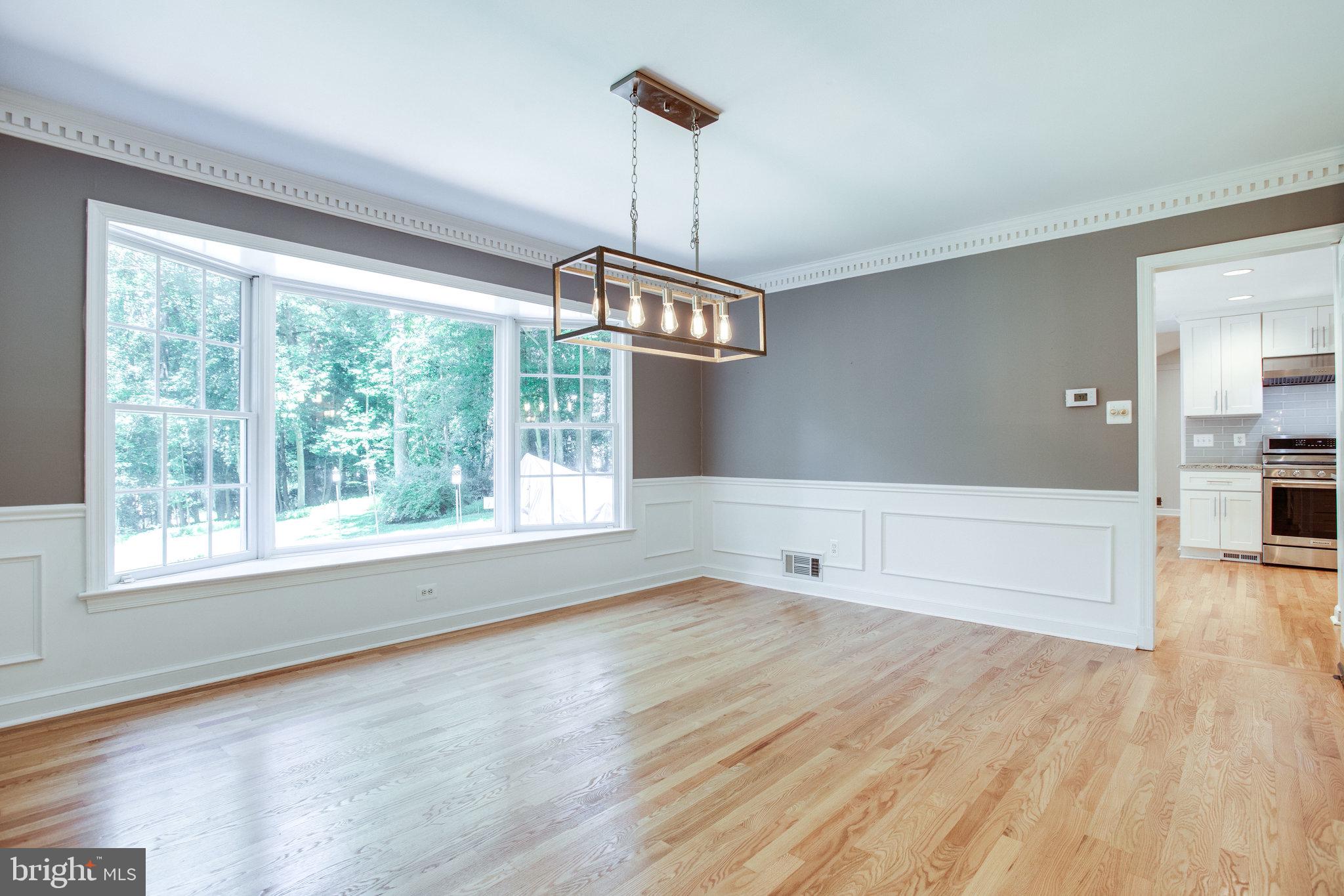 8500 Brook Road McLean, VA 22102 - Photo 7 of 52 a view of an empty room with wooden floor and a window