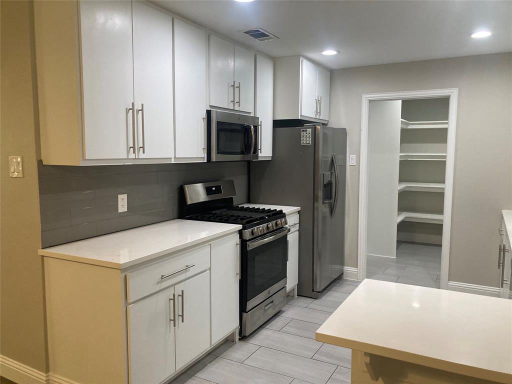 518 Burnwood Drive Irving, TX 75062 - Photo 1 of 18 a kitchen with stainless steel appliances a stove refrigerator sink and cabinets