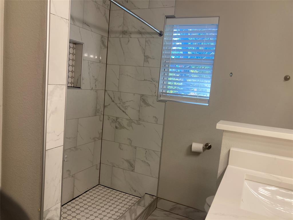 518 Burnwood Drive Irving, TX 75062 - Photo 12 of 18 a bathroom with a shower