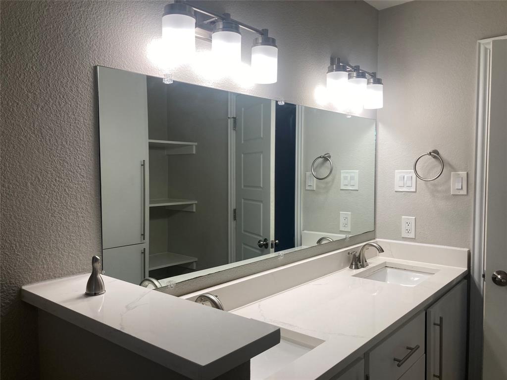 518 Burnwood Drive Irving, TX 75062 - Photo 13 of 18 a bathroom with a sink and a mirror