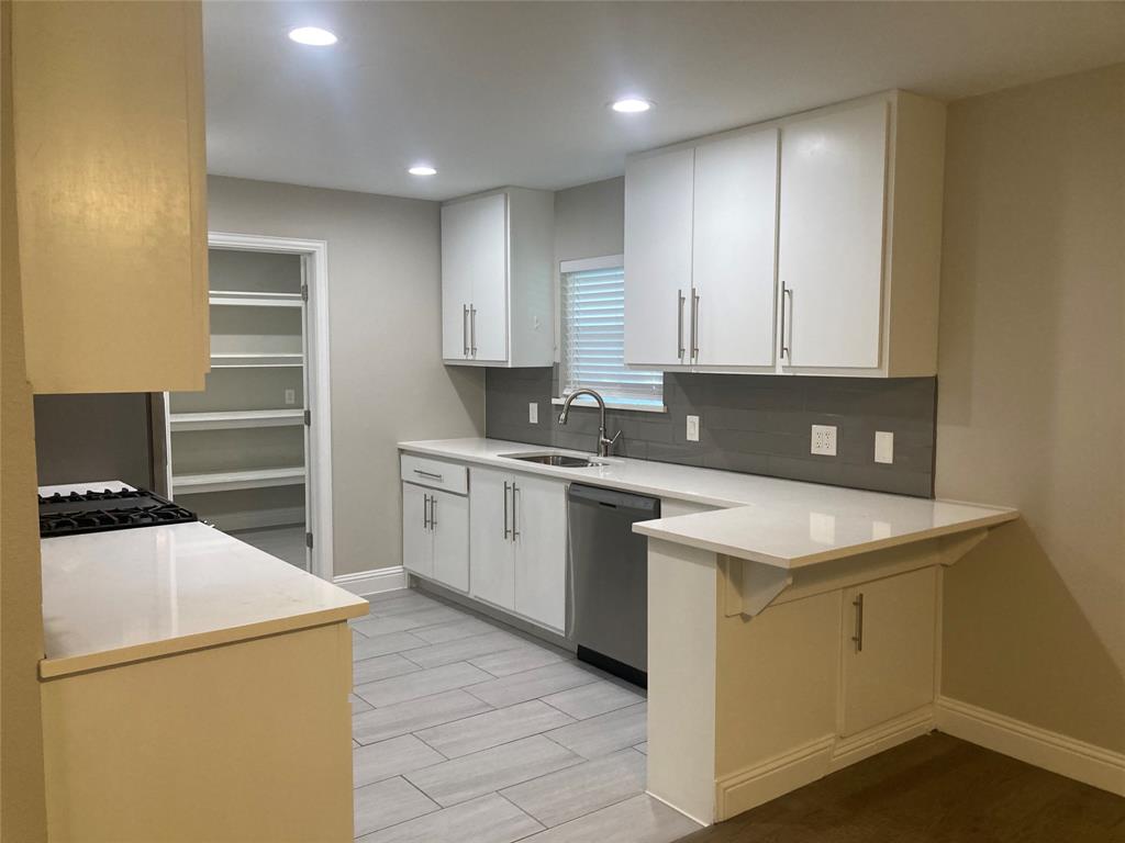 518 Burnwood Drive Irving, TX 75062 - Photo 2 of 18 a kitchen with a sink cabinets and appliances