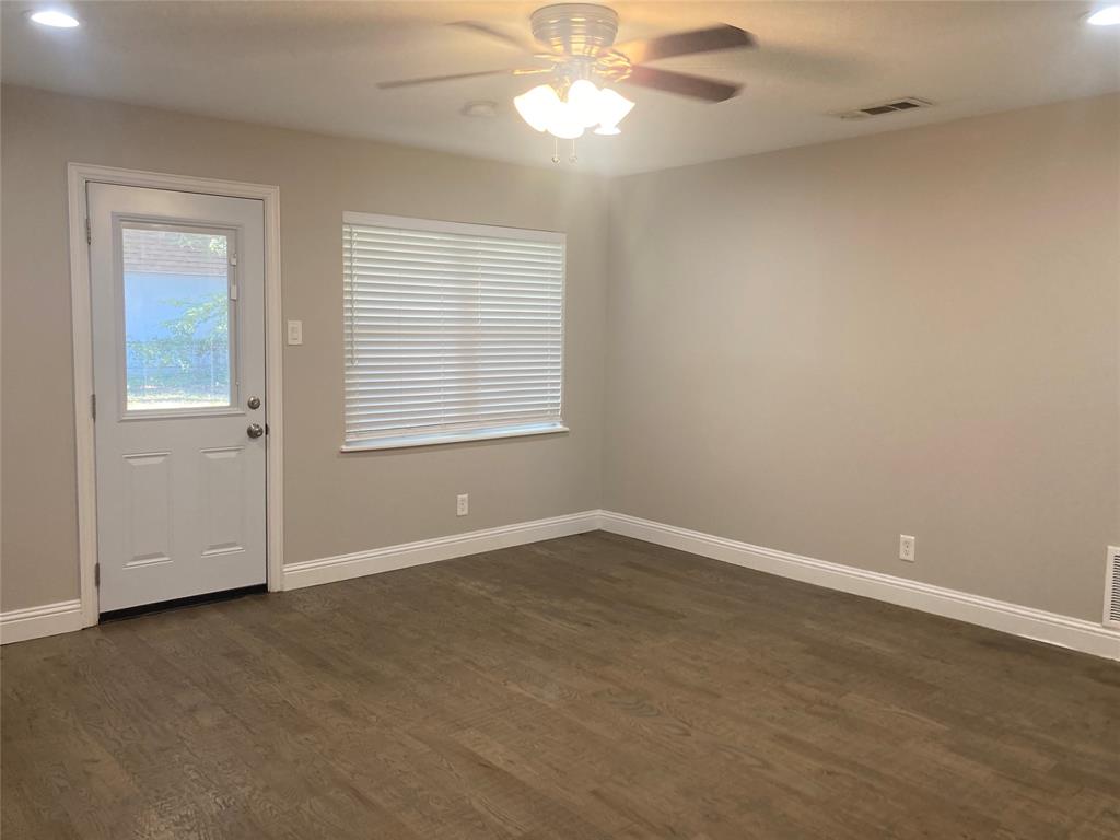518 Burnwood Drive Irving, TX 75062 - Photo 8 of 18 an empty room with a window and a ceiling fan
