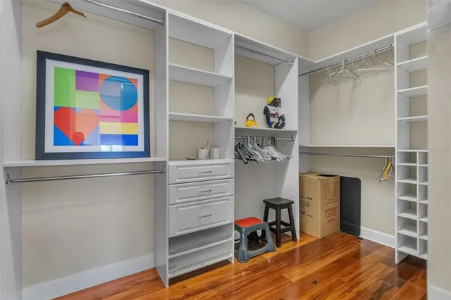 a view of a hallway with closet and a window
