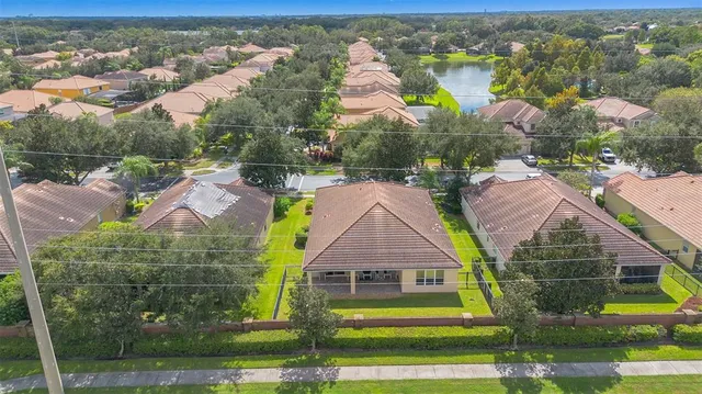 an aerial view of residential houses with outdoor space and swimming pool