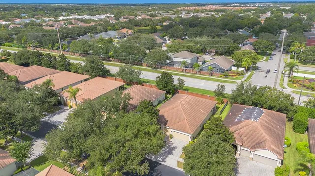 an aerial view of residential houses with outdoor space and river