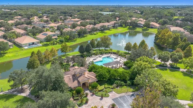 an aerial view of residential houses with outdoor space and river