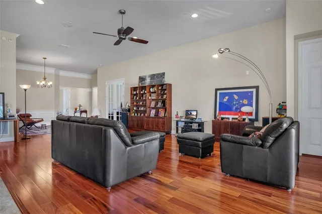 a living room with furniture and a wooden floor