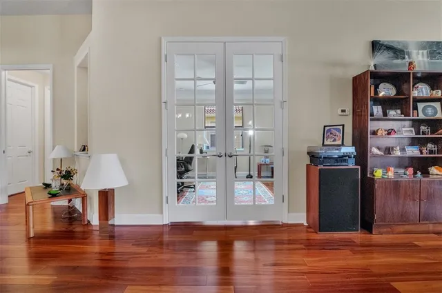 a view of a living room with furniture and wooden floor