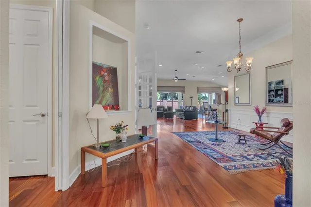 a living room with furniture and a chandelier