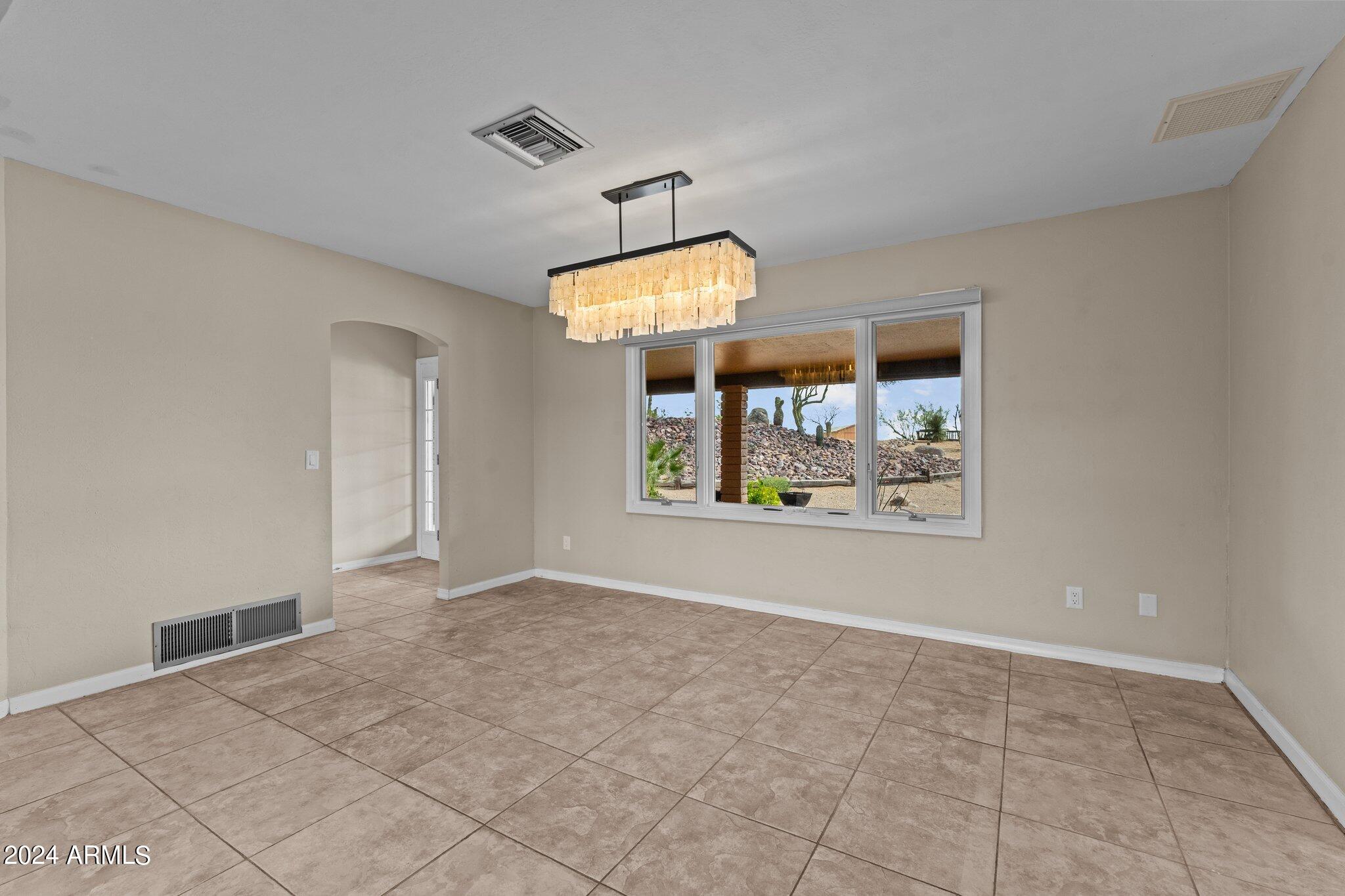 1605 North Little Stonehedge Ranch Road Wickenburg, AZ 85390 - Photo 17 of 54 an empty room with windows and outdoor view