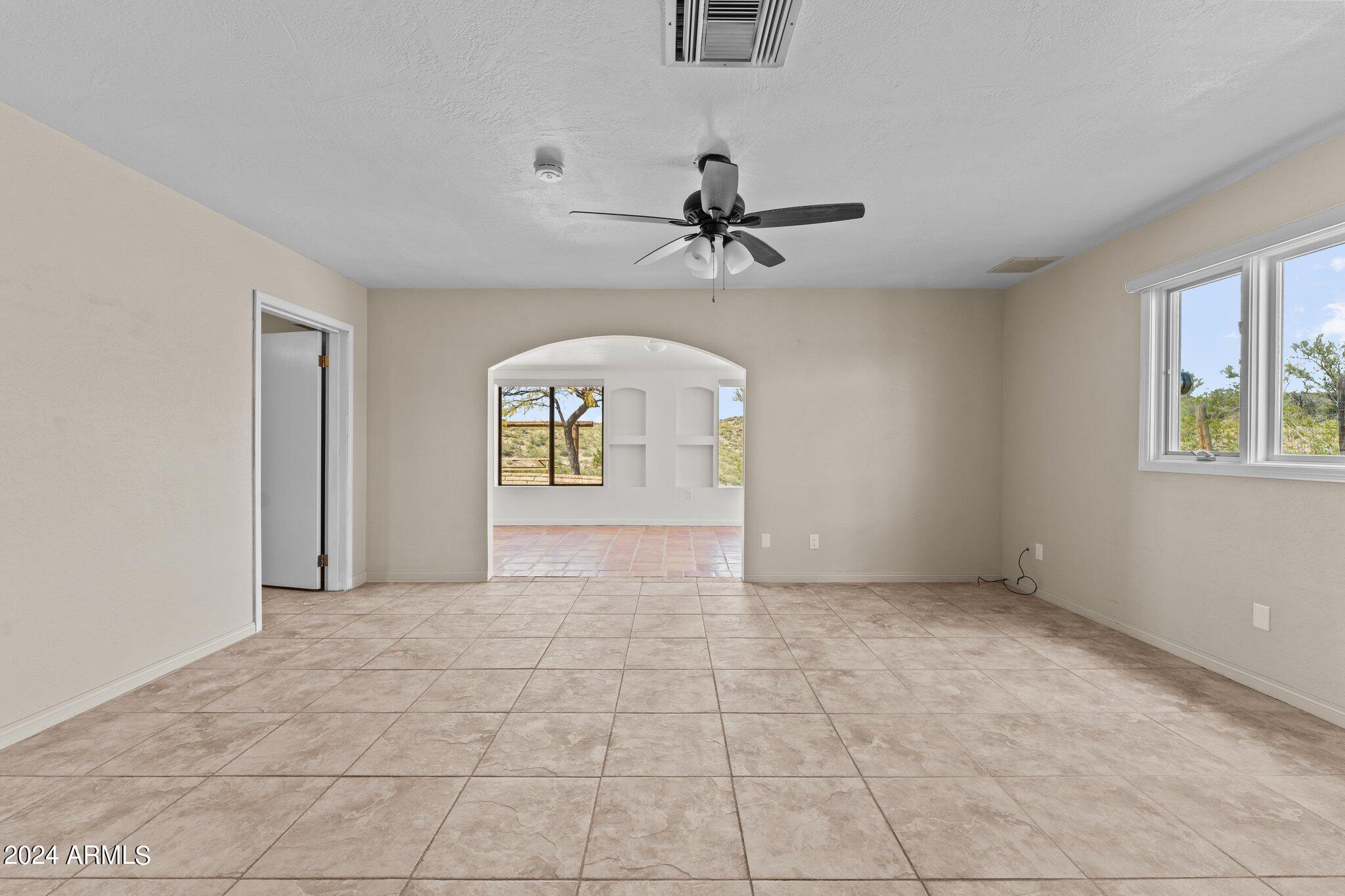 1605 North Little Stonehedge Ranch Road Wickenburg, AZ 85390 - Photo 19 of 54 wooden floor in an empty room with a window