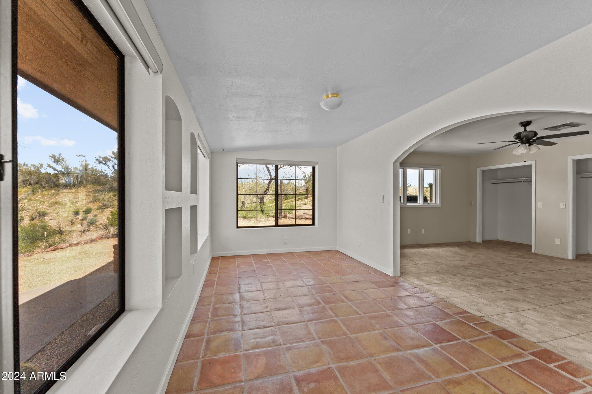 1605 North Little Stonehedge Ranch Road Wickenburg, AZ 85390 - Photo 20 of 54 a view of hallway with windows and chandelier