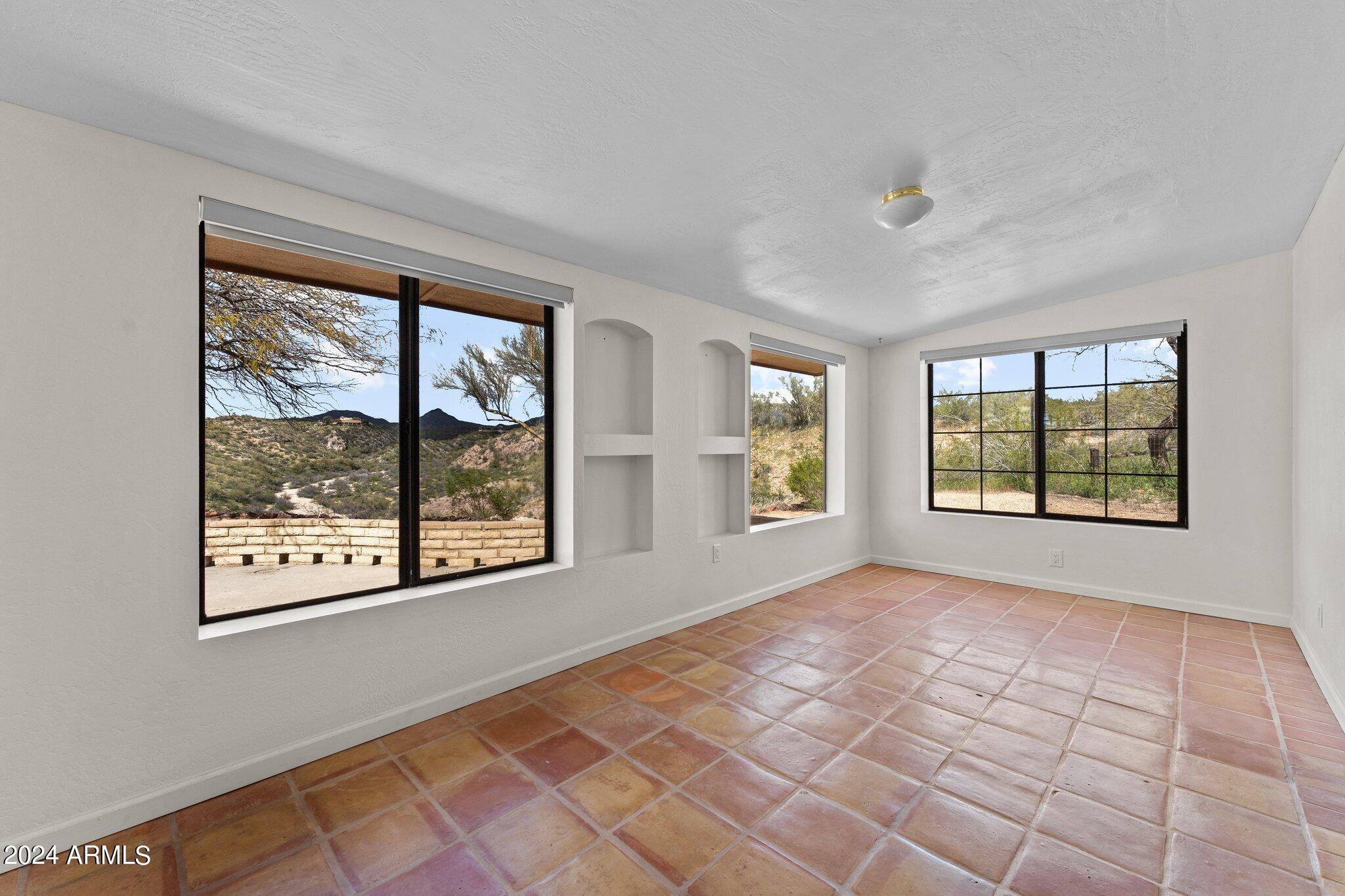 1605 North Little Stonehedge Ranch Road Wickenburg, AZ 85390 - Photo 21 of 54 a view of an empty room with a window
