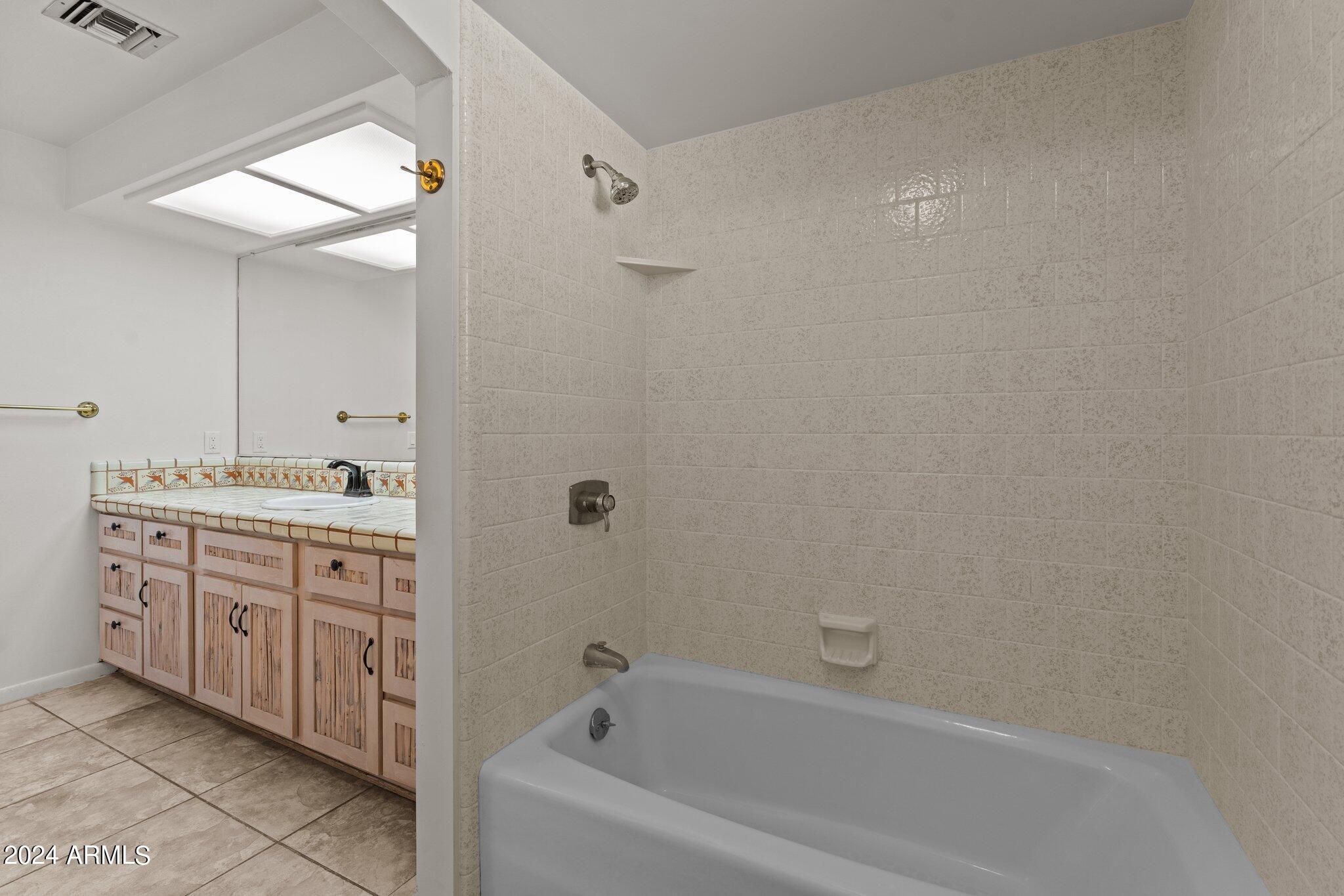 1605 North Little Stonehedge Ranch Road Wickenburg, AZ 85390 - Photo 25 of 54 a bathroom with a granite countertop sink mirror and a bathtub