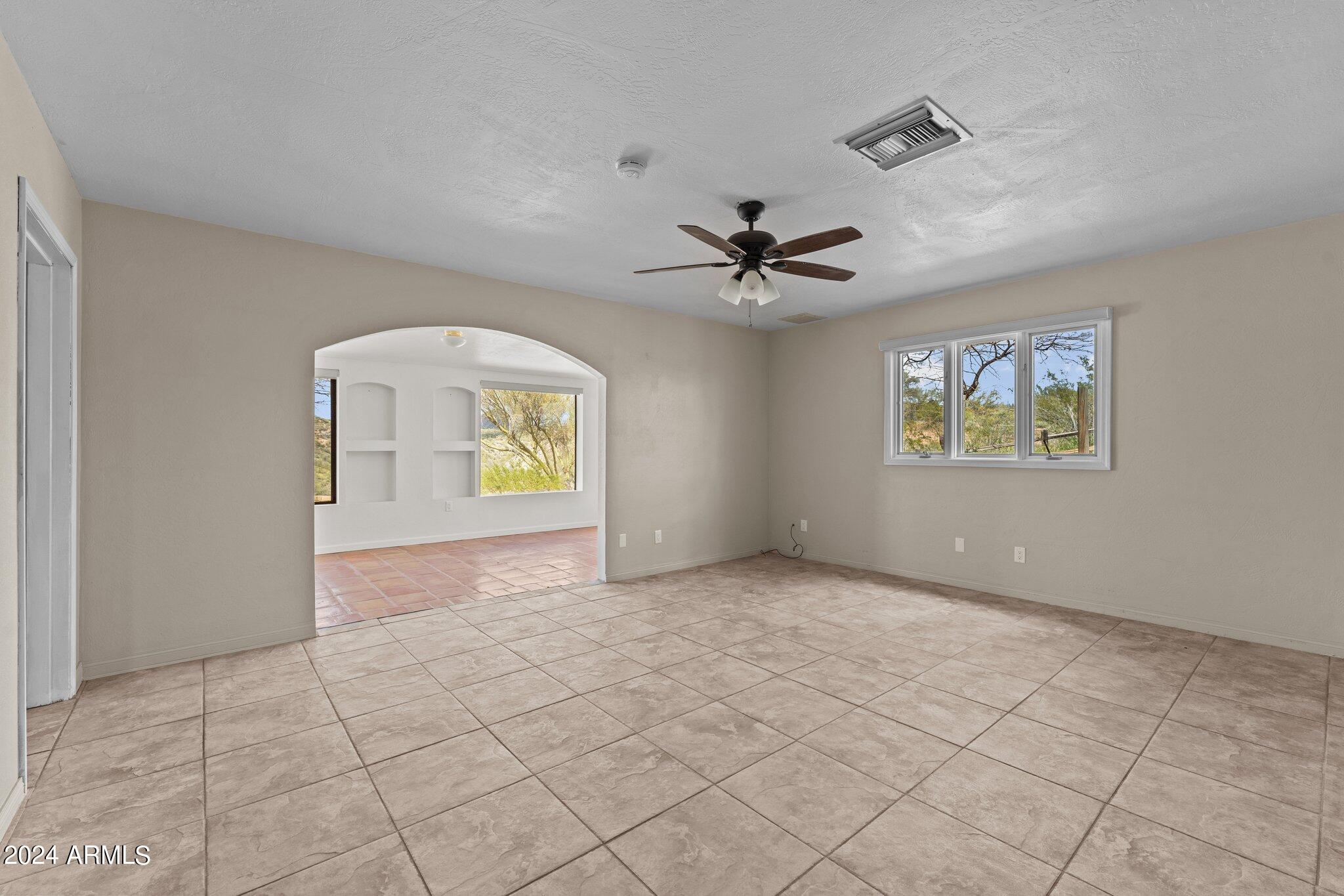 1605 North Little Stonehedge Ranch Road Wickenburg, AZ 85390 - Photo 3 of 54 a view of an empty room with a window