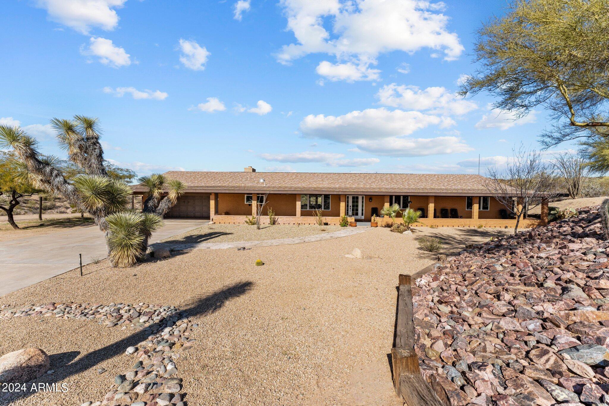 1605 North Little Stonehedge Ranch Road Wickenburg, AZ 85390 - Photo 32 of 54 a front view of a house with a yard
