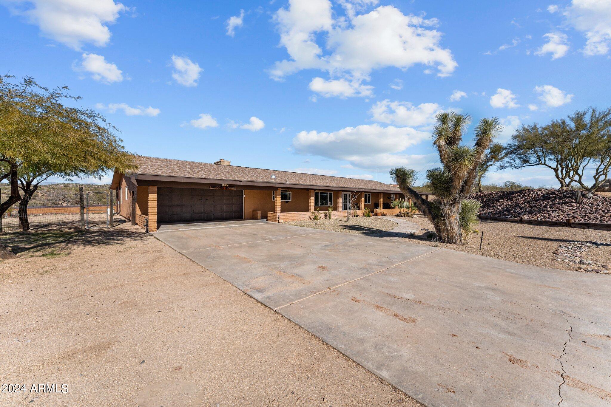1605 North Little Stonehedge Ranch Road Wickenburg, AZ 85390 - Photo 33 of 54 a front view of a house with a yard