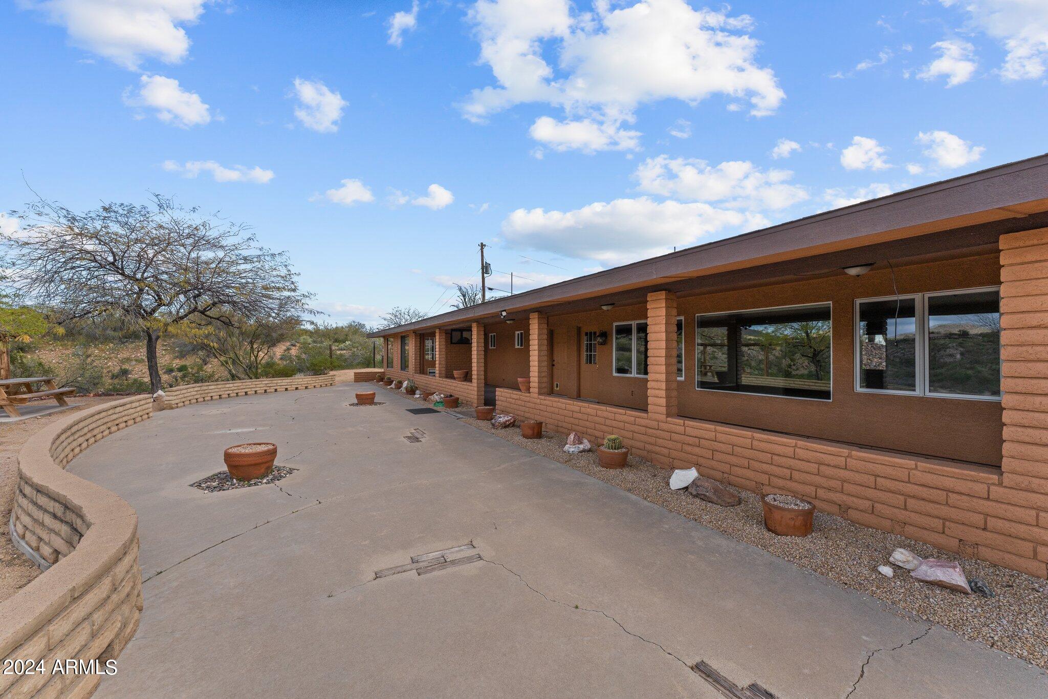 1605 North Little Stonehedge Ranch Road Wickenburg, AZ 85390 - Photo 39 of 54 a front view of a house with a yard
