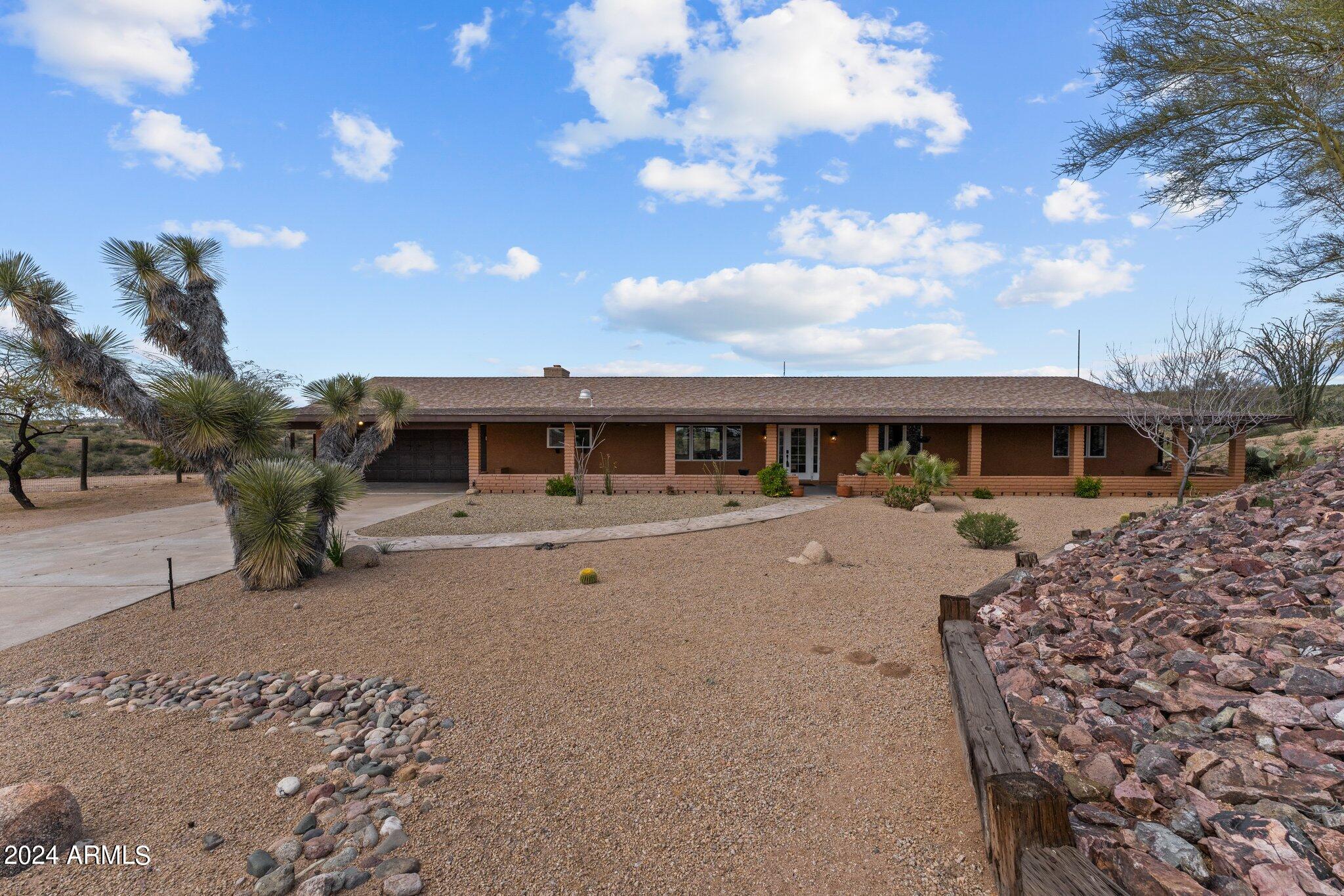 1605 North Little Stonehedge Ranch Road Wickenburg, AZ 85390 - Photo 53 of 54 a front view of a house with a yard