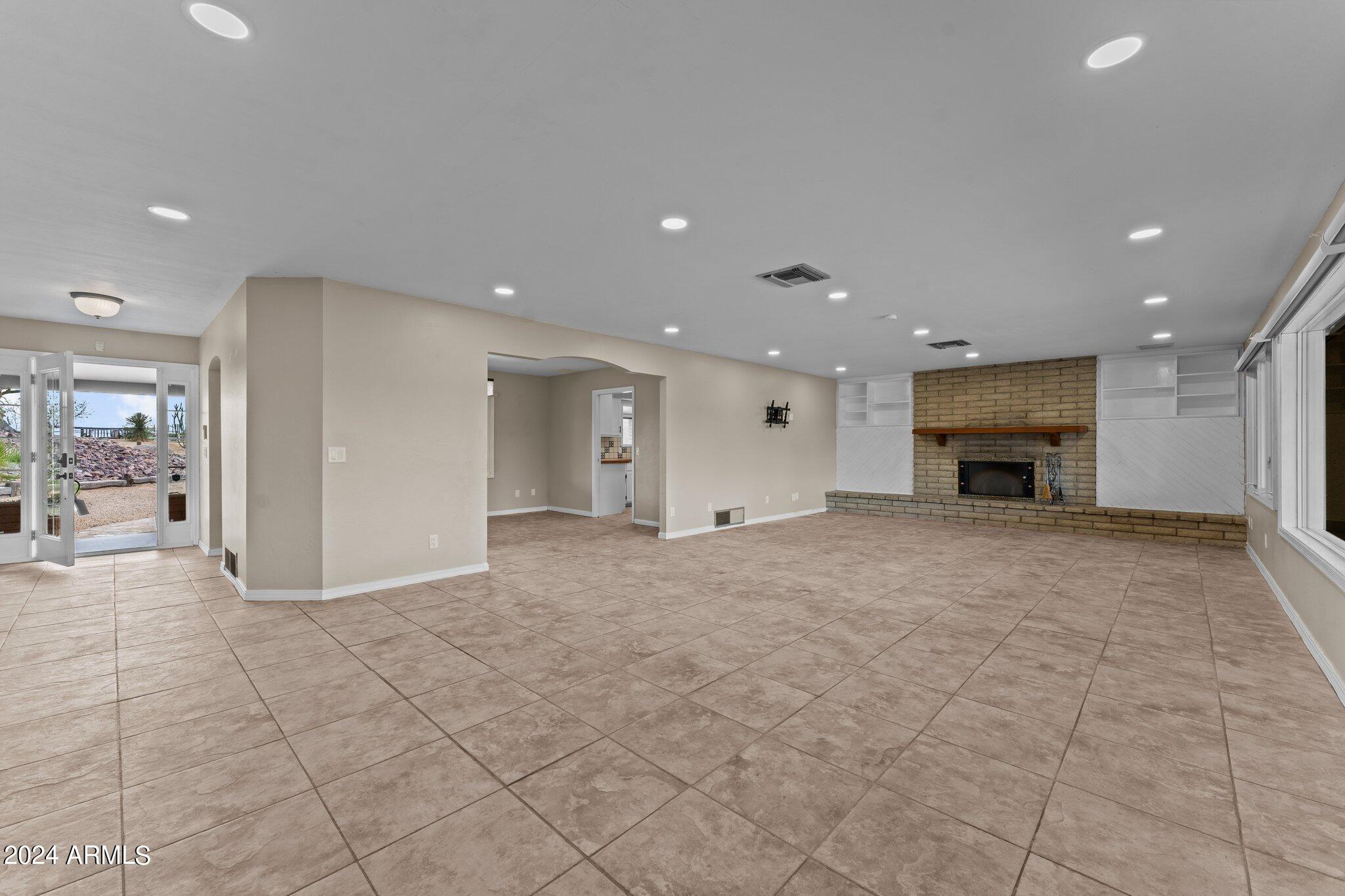 1605 North Little Stonehedge Ranch Road Wickenburg, AZ 85390 - Photo 10 of 54 a view of an empty room with a fireplace