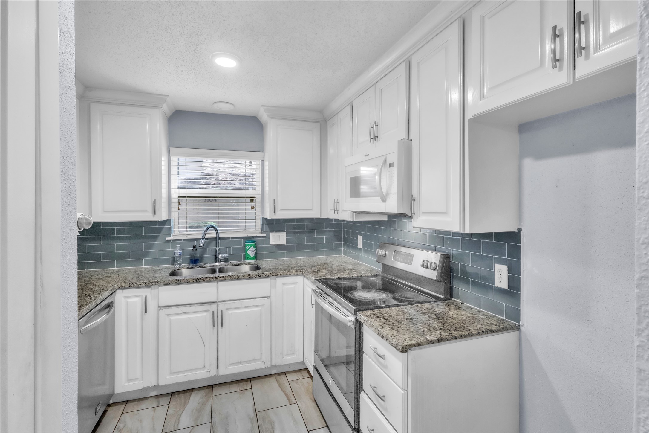 7044 South Dairy Ashford Road Houston, TX 77072 - Photo 14 of 30 a kitchen with a sink stove and cabinets